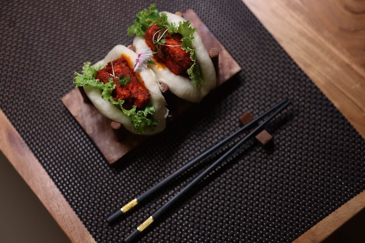 Chilli-topped bao on a dark placemat