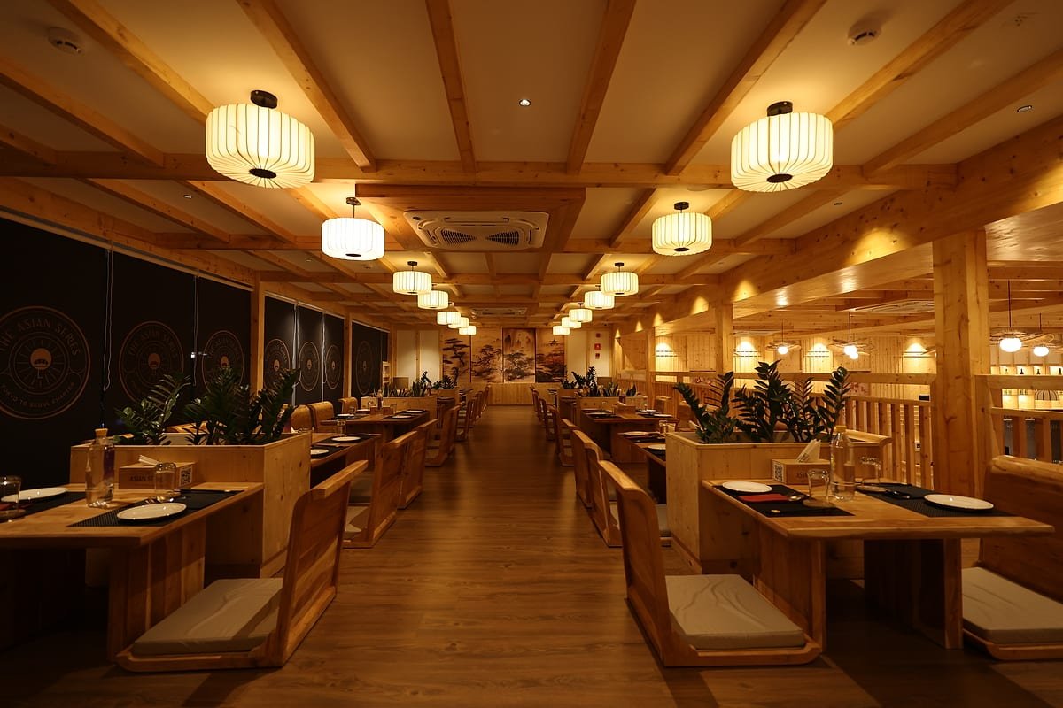 The full length of the dining room, booths under paper lanterns