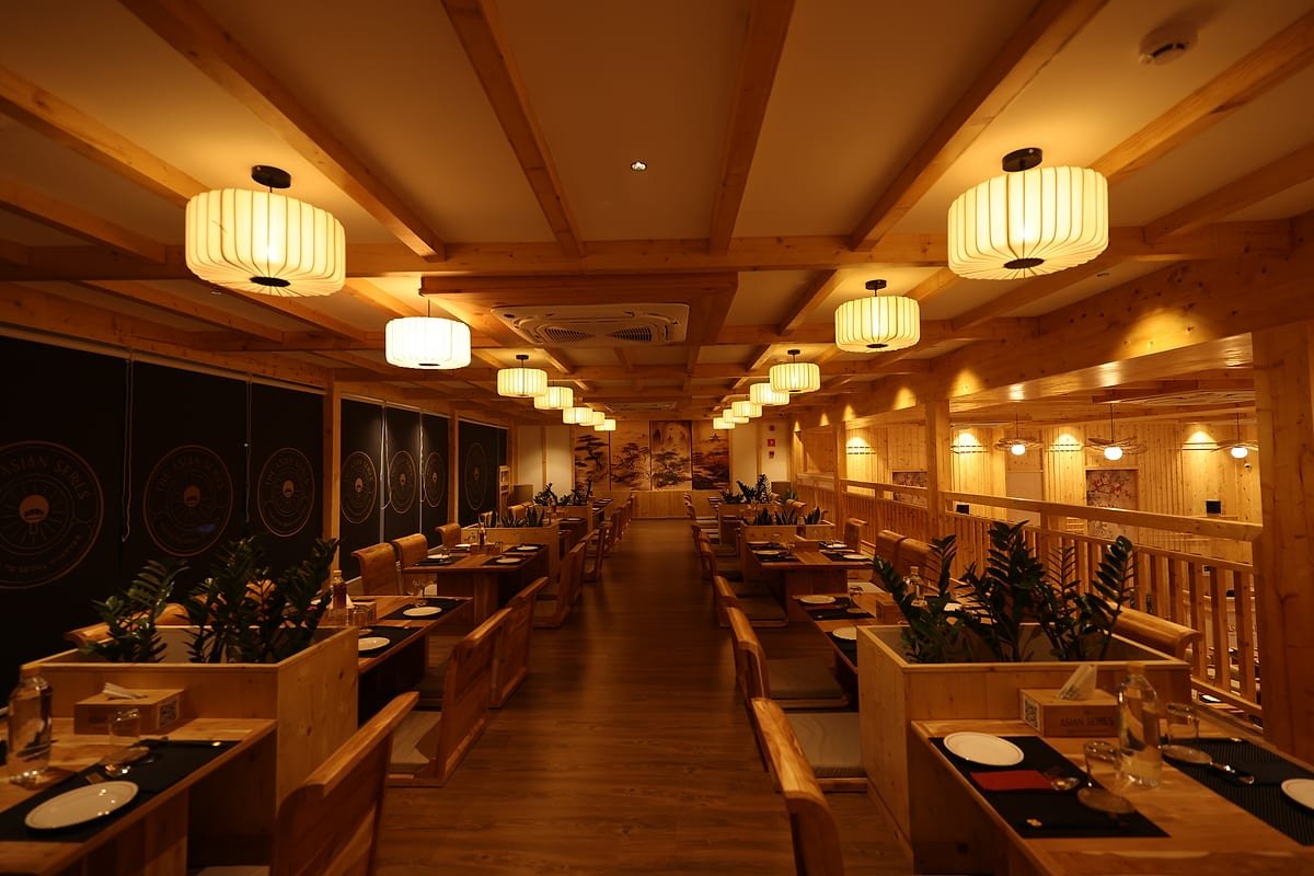 The cedar-lined dining room at The Asian Series, lit by paper lanterns